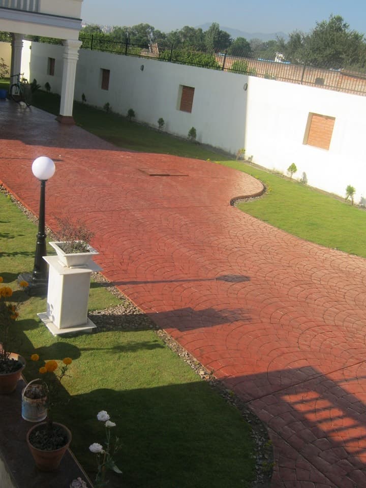 Stamped concrete driveway through a garden